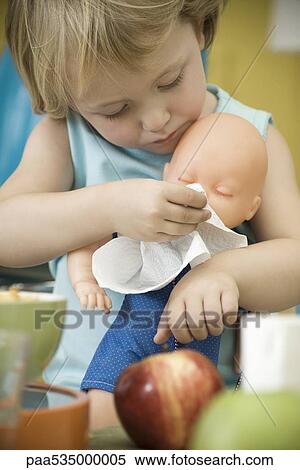 Little girl wiping baby doll's face with paper towel View Large Photo Image Stock Photography - Little girl wiping baby doll's face with paper towel. Fotosearch