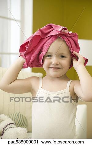 Toddler girl with shirt on head, portrait View Large Photo Image Stock Image - Toddler girl with shirt on head, portrait. Fotosearch