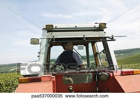 France, Champagne-Ardenne, Aube, man driving tractor, rear view View Large Photo Image Stock Photography - France, Champagne-Ardenne, Aube, man driving tractor, rear view. Fotosearch