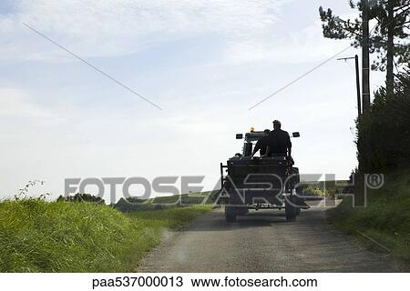 Stock Image - France, Champagne-Ardenne, Aube, truck driving along country road, rear view. Fotosearch