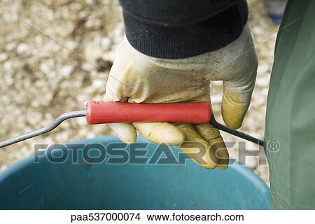 Gloved hand carrying bucket, cropped View Large Photo Image Picture - Gloved hand carrying bucket, cropped. Fotosearch