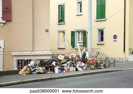 Stock Image - Abandoned furniture, junk, garbage piled up on sidewalk. Fotosearch