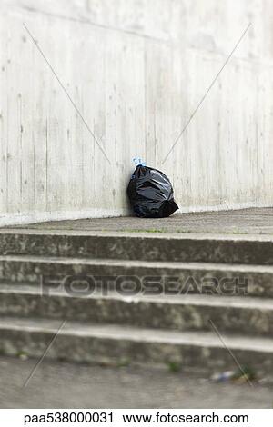 Bag of garbage sitting at top of steps View Large Photo Image Stock Image - Bag of garbage sitting at top of steps. Fotosearch