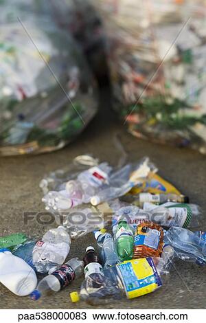 Crushed plastic bottles on ground, garbage bags in background View Large Photo Image Stock Image - Crushed plastic bottles on ground, garbage bags in background. Fotosearch