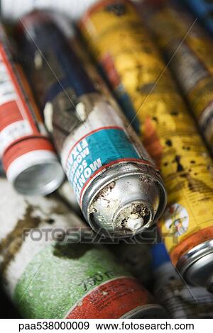 Stock Photo - Discarded aerosol cans, close-up. Fotosearch