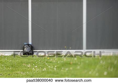 Stock Image - Garbage bag leaning against wall. Fotosearch