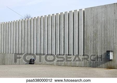 Stock Image - Garbage bag resting against side of building. Fotosearch