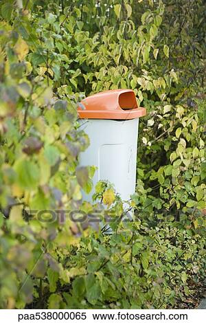 Stock Photography - Garbage can in woods. Fotosearch