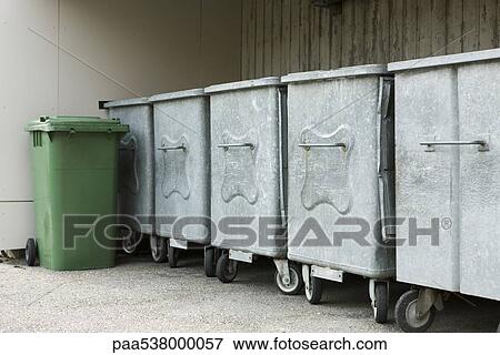 Stock Photo - Garbage cans lined up along wall. Fotosearch
