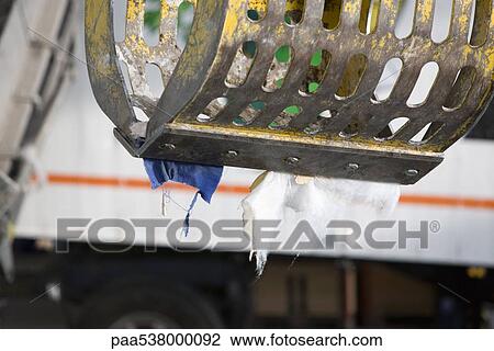 Grapple holding scraps of garbage View Large Photo Image Stock Image - Grapple holding scraps of garbage. Fotosearch