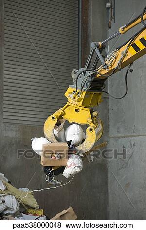 Grapple picking up trash View Large Photo Image Stock Photo - Grapple picking up trash. Fotosearch