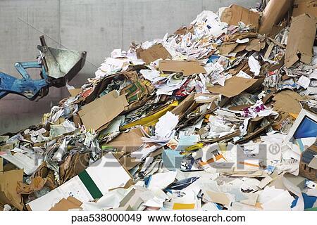 Stock Photo - Large heap of paper and cardboard in recycling center. Fotosearch