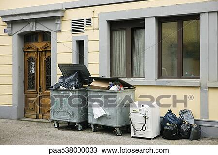 Overflowing trash bins in front of building View Large Photo Image Stock Image - Overflowing trash bins in front of building. Fotosearch