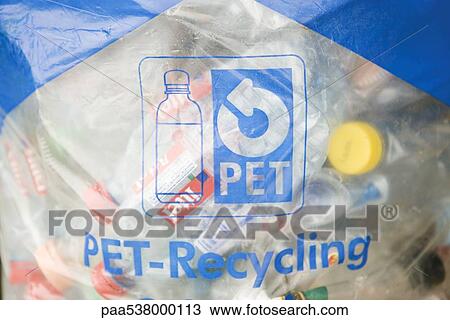 Stock Image - Plastic recycling bag filled with bottles. Fotosearch