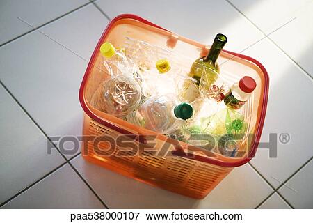 Stock Photo - Recycling bin filled with plastic and glass bottles. Fotosearch
