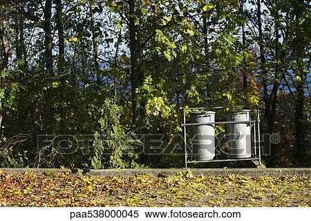Trash cans on curb along wooded area View Large Photo Image Stock Photography - Trash cans on curb along wooded area. Fotosearch