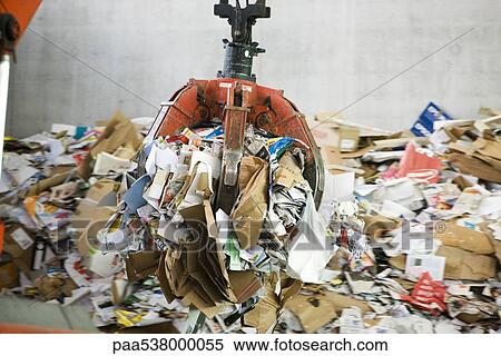 Stock Photography - Waste paper being processed in recycling center. Fotosearch