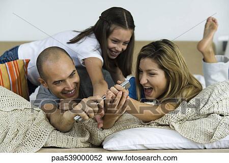 Family fighting over remote control, laughing View Large Photo Image Stock Image - Family fighting over remote control, laughing. Fotosearch