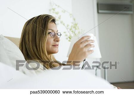 Woman holding cup, looking away, profile View Large Photo Image Stock Image - Woman holding cup, looking away, profile. Fotosearch