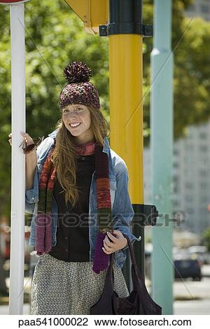 Young woman in trendy clothing, smiling View Large Photo Image Stock Image - Young woman in trendy clothing, smiling. Fotosearch