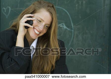 Young woman with strawberry blonde hair talking on cell phone View Large Photo Image Stock Photo - Young woman with strawberry blonde hair talking on cell phone. Fotosearch