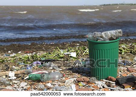 Garbage can overflowing with plastic bottles on polluted shore View Large Photo Image Stock Image - Garbage can overflowing with plastic bottles on polluted shore. Fotosearch