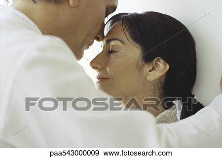 Couple standing close together, face to face, eyes closed, cropped View Large Photo Image Stock Photo - Couple standing close together, face to face, eyes closed, cropped. Fotosearch