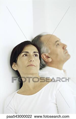 Man and woman sitting, leaning against each other looking away View Large Photo Image Stock Image - Man and woman sitting, leaning against each other looking away. Fotosearch
