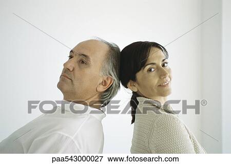 Mature couple standing back to back, leaning backwards, touching heads View Large Photo Image Stock Photo - Mature couple standing back to back, leaning backwards, touching heads. Fotosearch