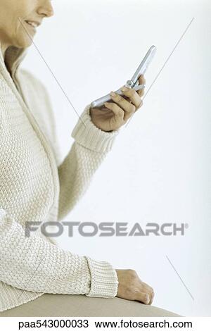 Woman looking at cell phone View Large Photo Image Stock Image - Woman looking at cell phone. Fotosearch