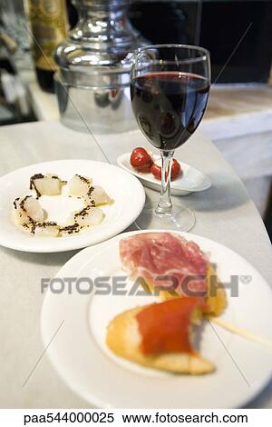 Appetizers and glass of red wine View Large Photo Image Stock Photography - Appetizers and glass of red wine. Fotosearch