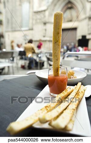 Breadstick dipped in sauce View Large Photo Image Stock Photograph - Breadstick dipped in sauce. Fotosearch