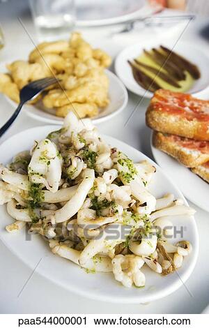 Calamari fried and steamed with other appetizers View Large Photo Image Stock Image - Calamari fried and steamed with other appetizers. Fotosearch