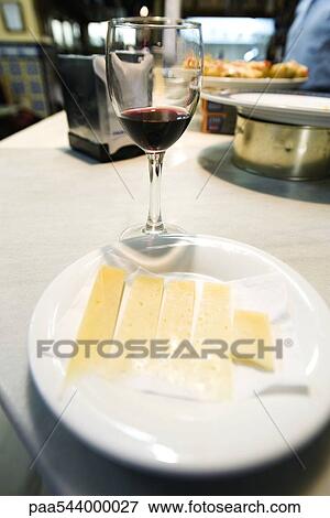 Cheese plate with glass of red wine View Large Photo Image Stock Photo - Cheese plate with glass of red wine. Fotosearch