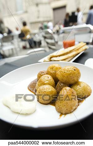 Small roasted potatoes with sauce View Large Photo Image Stock Image - Small roasted potatoes with sauce. Fotosearch