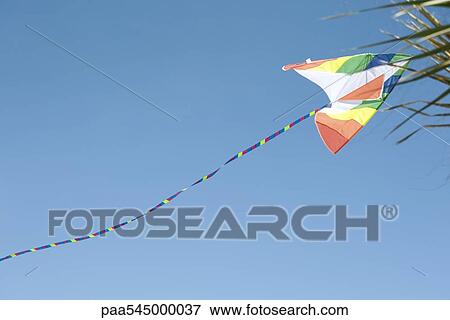 Colorful kite in midair View Large Photo Image Stock Photo - Colorful kite in midair. Fotosearch