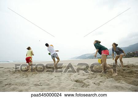 Teen friends playing paddleball on beach View Large Photo Image Picture - Teen friends playing paddleball on beach. Fotosearch