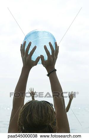 Teen girl catching ball with arms raised, cropped View Large Photo Image Stock Photo - Teen girl catching ball with arms raised, cropped. Fotosearch