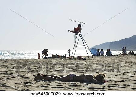Teen girl sunbathing on beach View Large Photo Image Stock Photo - Teen girl sunbathing on beach. Fotosearch