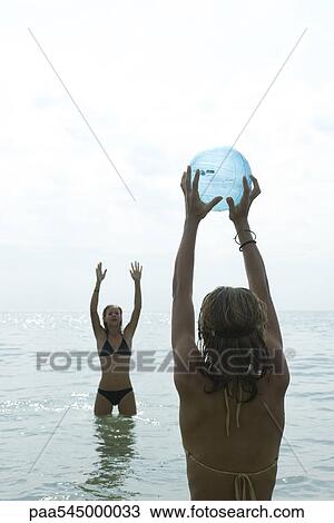 Teen girls playing with beach ball in sea View Large Photo Image Stock Image - Teen girls playing with beach ball in sea. Fotosearch