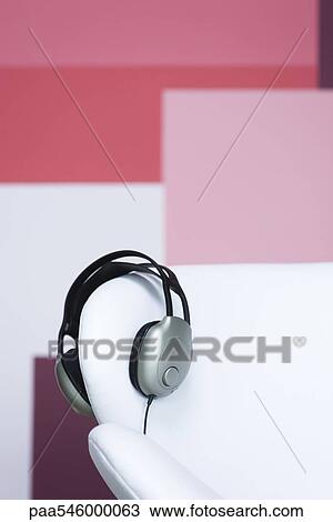 Headphones on arm of sofa View Large Photo Image Stock Image - Headphones on arm of sofa. Fotosearch