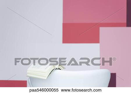 Open book on back of armchair View Large Photo Image Stock Photography - Open book on back of armchair. Fotosearch