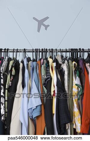 Rack of clothing, airplane in background View Large Photo Image Stock Photo - Rack of clothing, airplane in background. Fotosearch