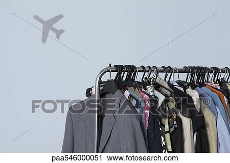 Rack of clothing, airplane shape in background View Large Photo Image Stock Image - Rack of clothing, airplane shape in background. Fotosearch