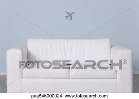 Sofa and airplane shape in background View Large Photo Image Picture - Sofa and airplane shape in background. Fotosearch