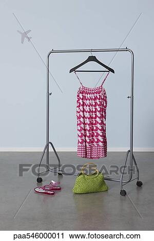 Summery woman's outfit on clothes rack, plane image in background View Large Photo Image Stock Image - Summery woman's outfit on clothes rack, plane image in background. Fotosearch