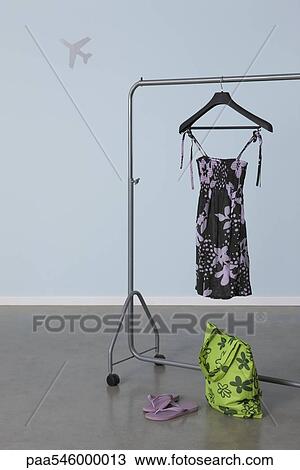 Summery woman's outfit on clothes rack, plane image in background View Large Photo Image Stock Image - Summery woman's outfit on clothes rack, plane image in background. Fotosearch
