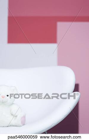 Teddy bear sitting on armchair View Large Photo Image Stock Photo - Teddy bear sitting on armchair. Fotosearch
