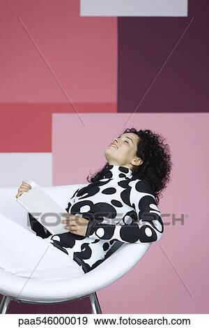 Woman enjoying book, leaning back with eyes closed, smiling View Large Photo Image Stock Photo - Woman enjoying book, leaning back with eyes closed, smiling. Fotosearch