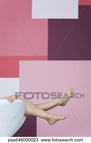 Woman reclining on armchair, cropped view of bare legs View Large Photo Image Stock Image - Woman reclining on armchair, cropped view of bare legs. Fotosearch
